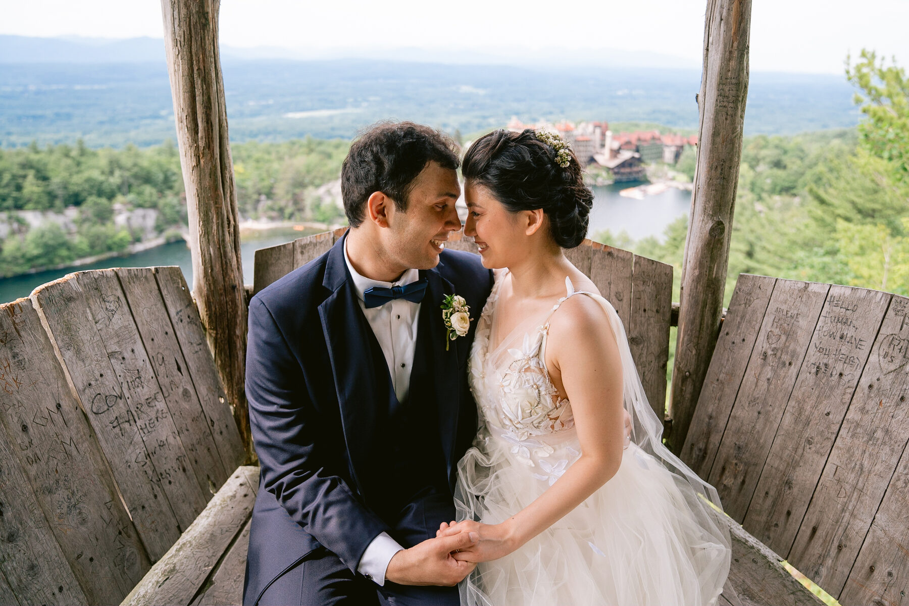 Bride and groom embrace at a scenic mountaintop wedding venue