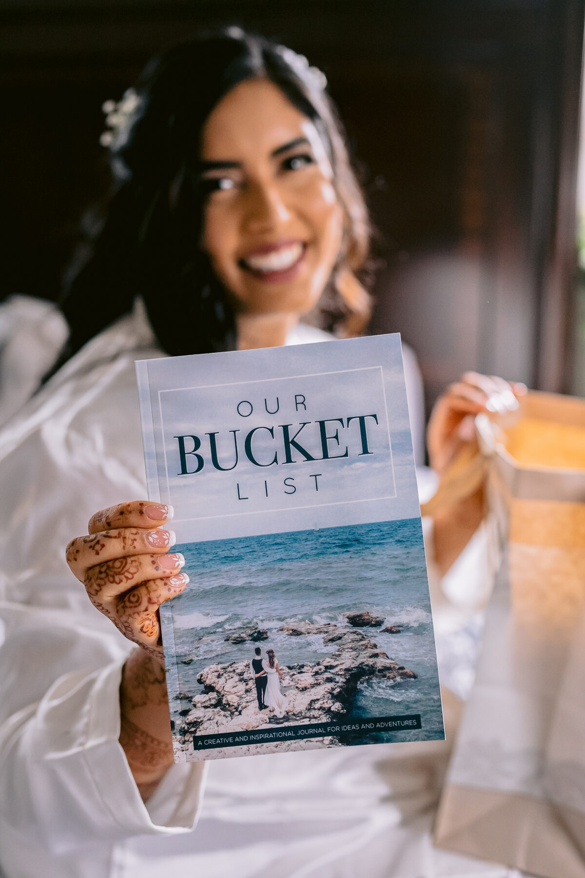 Bride smiling while holding a keepsake book