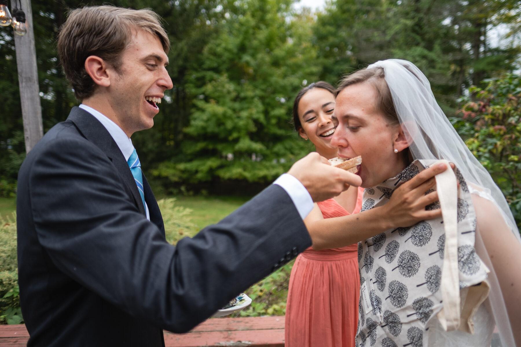 Bride and groom sharing a joyful candid moment outdoors