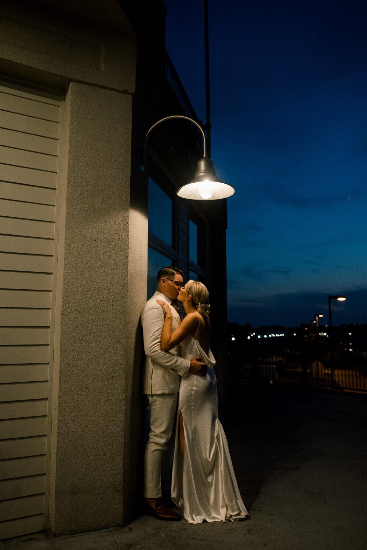 Couple embracing at night against city lights