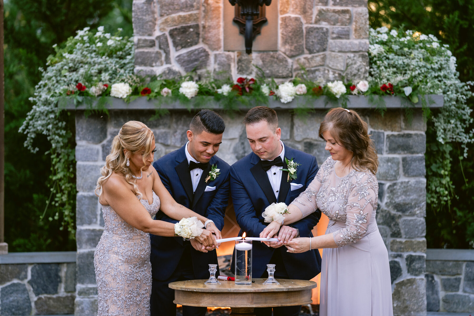 Wedding ceremony unity-candle moment at a stone fireplace